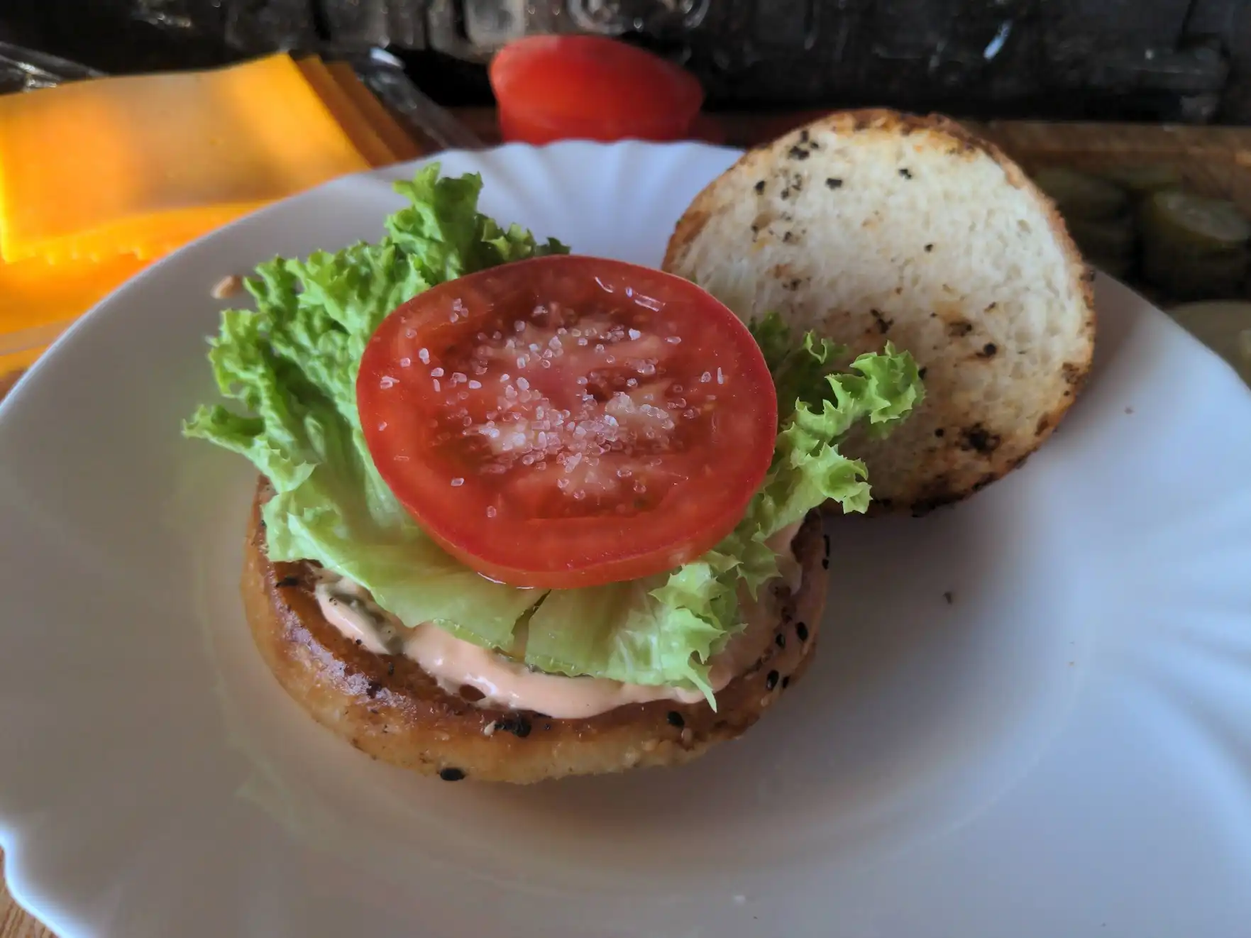 Adding the salad and tomato.
