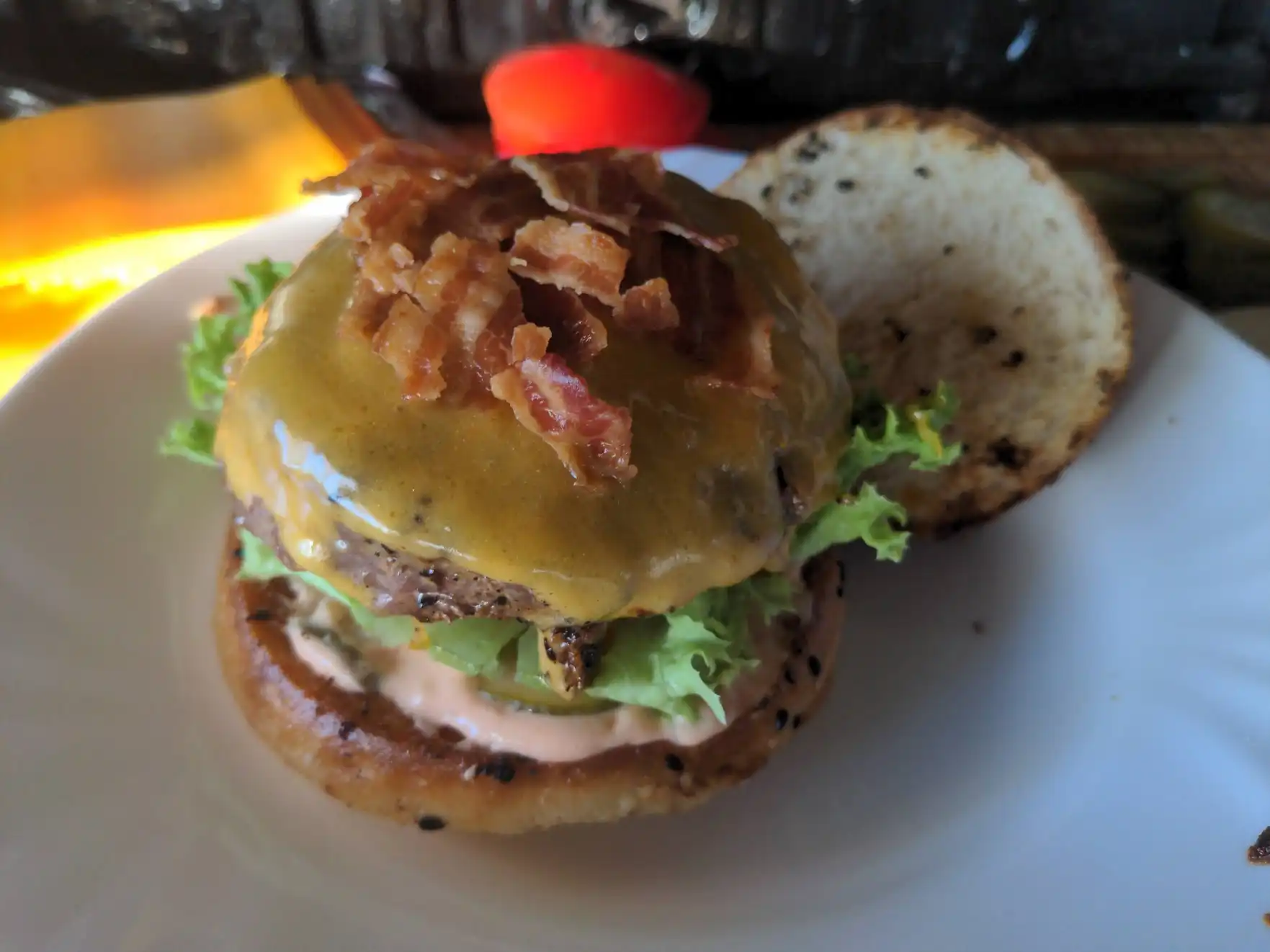 Adding the patty and bacon.